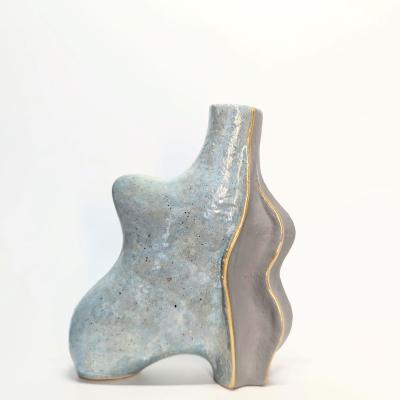 Handmade ceramic oil bottle created using the carton technique, featuring relief lines for stability, crafted in a two-session pottery class.